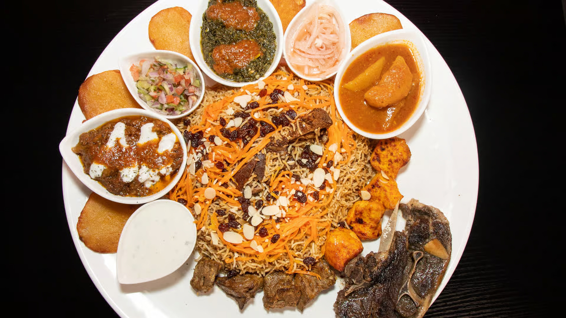 Pamir Platter - A magnificent feast featuring tender lamb, aromatic rice, and traditional Afghan accompaniments